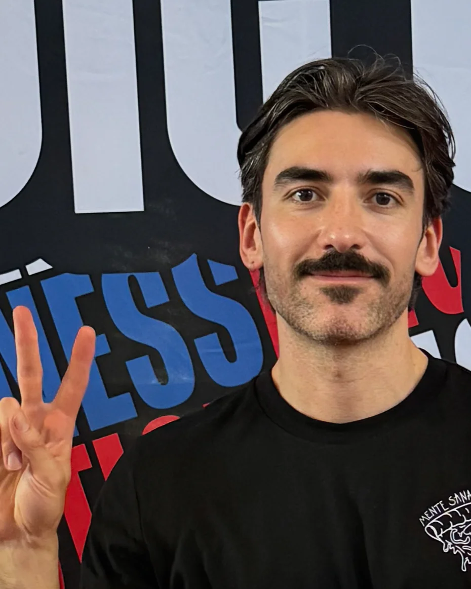 Javi San Juan smiling and making a peace sign